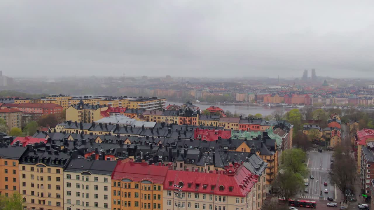 Wide aerial shot of Stockholm’s skyline, fading into the distance under a soft and misty atmosphere