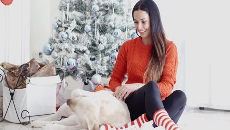 Young-woman-having-fun-with-her-golden-labrador