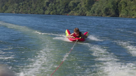 child tubing on a river