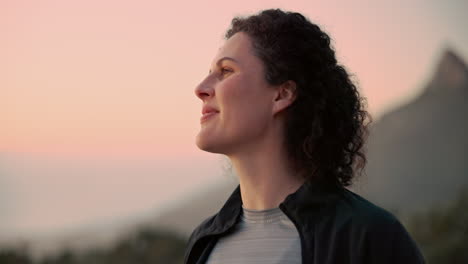 woman enjoying sunset view from mountaintop