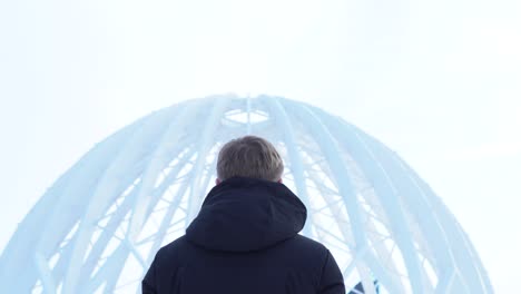 man looking at a dome structure