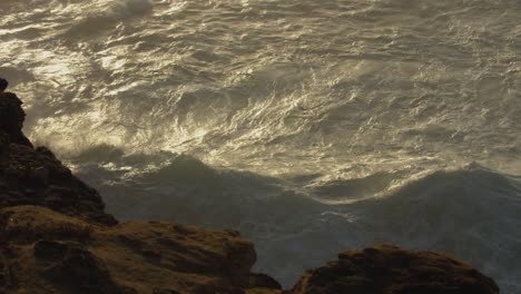 golden seascape along the portuguese coastline with rocky clifftops in nazare