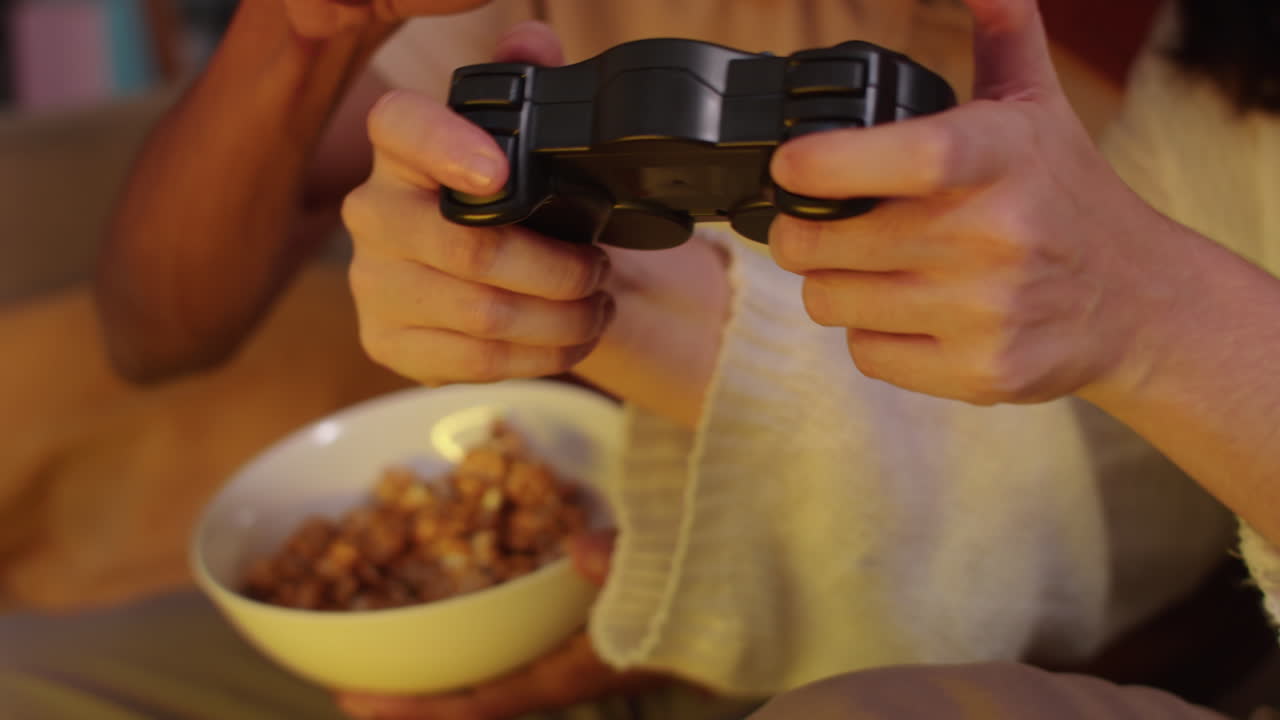 Excited Biracial Man and Woman Using Console to Play Video Games