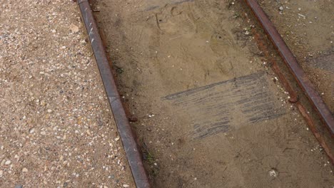 rusty tracks on a dirt path