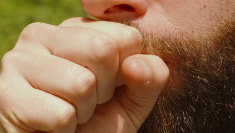 close up of coughing diseased caucasian sick bearded man showing covid symptoms