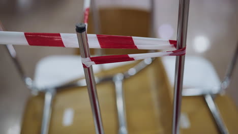 chair legs wrapped with warning strip in closed restaurant