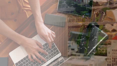 animación de una mujer de negocios caucásica usando una computadora portátil sobre el paisaje urbano