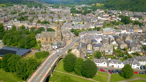 aerial drone shot flying from the tweed bridge towards peebles old parish church in the town of peebles n the scottish borders