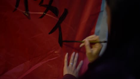 4k asian woman writting chinese words in traditional lantern during festival