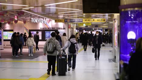 passengers walking through a busy station