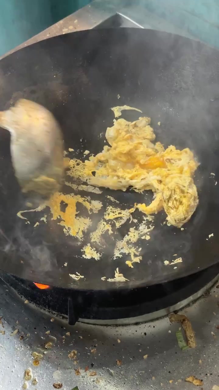 Chef Scrambling Eggs in a Hot Wok