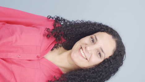 Vertical-video-of-The-young-woman-making-cute-gestures-for-the-camera.