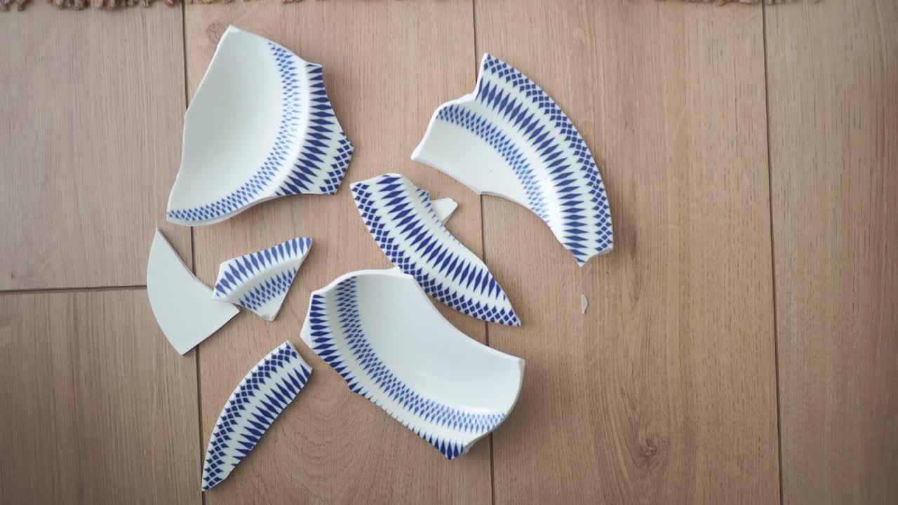 Broken Plate on Wooden Floor