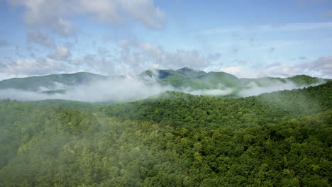 high-altitude drone view of mist swirling over the smoky mountains in the united states