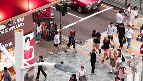 people crossing street near jewelry store