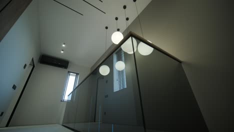 modern hallway with pendant lighting and wood paneling