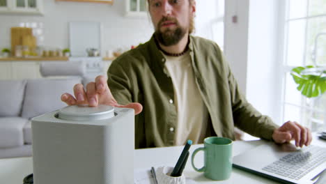 close up view of man sitting at desk in the living room