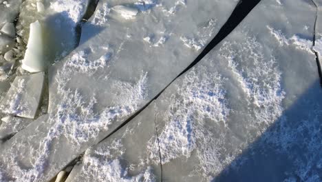 Ice-breaks-as-the-Ice-breaker-goes-through-thick-ice-floating-in-the-water-on-Lapland-Finland-Aerial