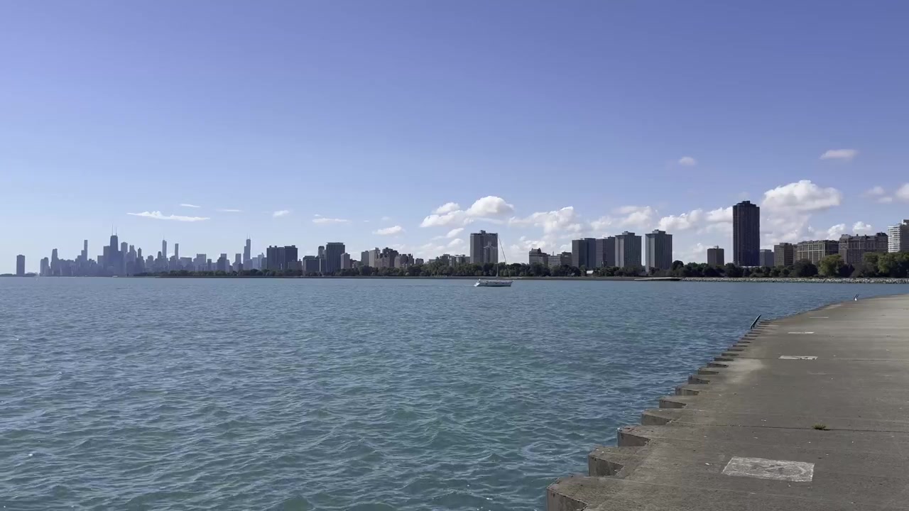 Scenic footage of Lake Michigan with gentle waves and the beautiful Chicago shoreline creating a peaceful waterfront atmosphere.