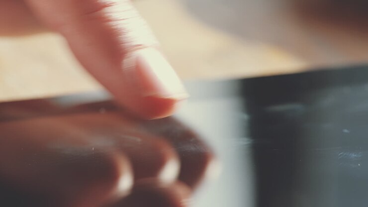 Close up hands touching tablet computer
