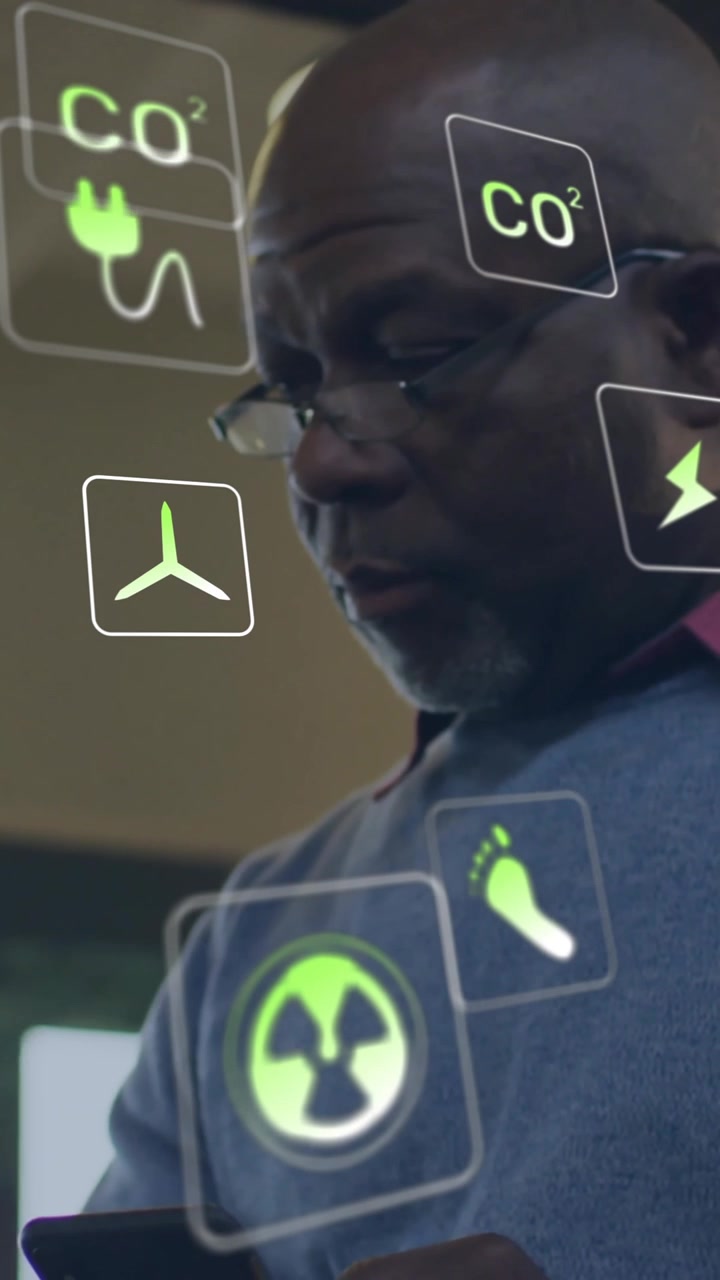 Animation of ecology icons over senior african american man using smartphone at home