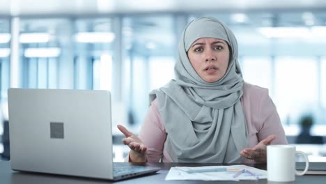 angry muslim businesswoman talking to camera