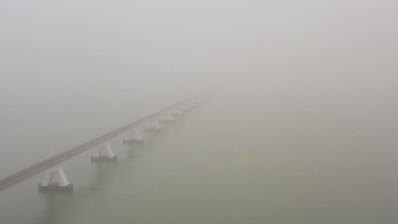 The Zeeland bridge disappearing in the thick fog. Drone shot