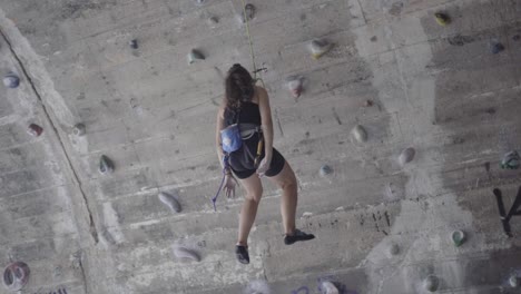 fearless adventurous young woman rock climbing at la foixarda barcelona