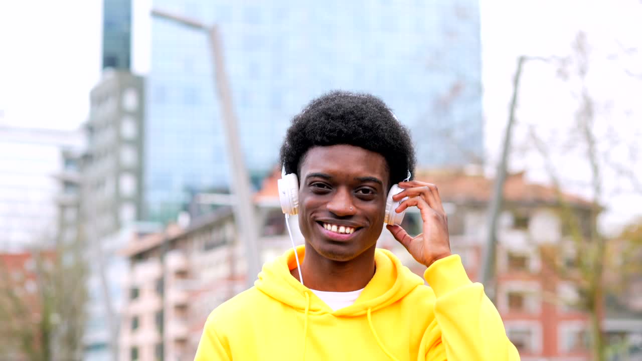 Young man with headphones in urban setting