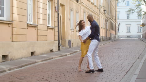 interracial couple dancing bachata in the old town street 12