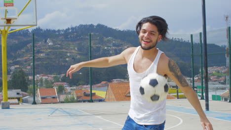 handsome man practicing soccer tricks