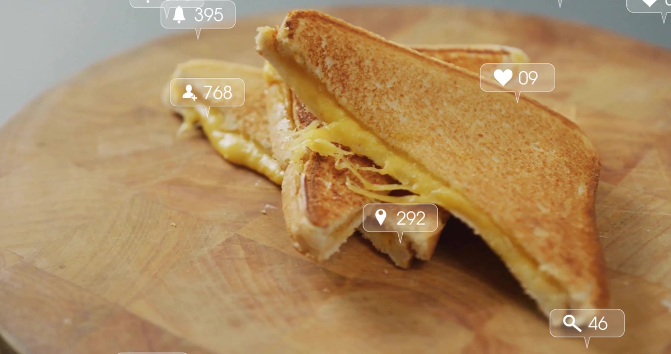 Grilled cheese sandwich spilling gooey cheese on wooden board showing floating social media alerts