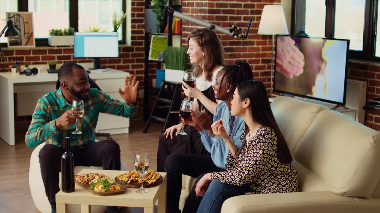 Woman enjoying talking with mates, having fun together, eating snacks in modern living room