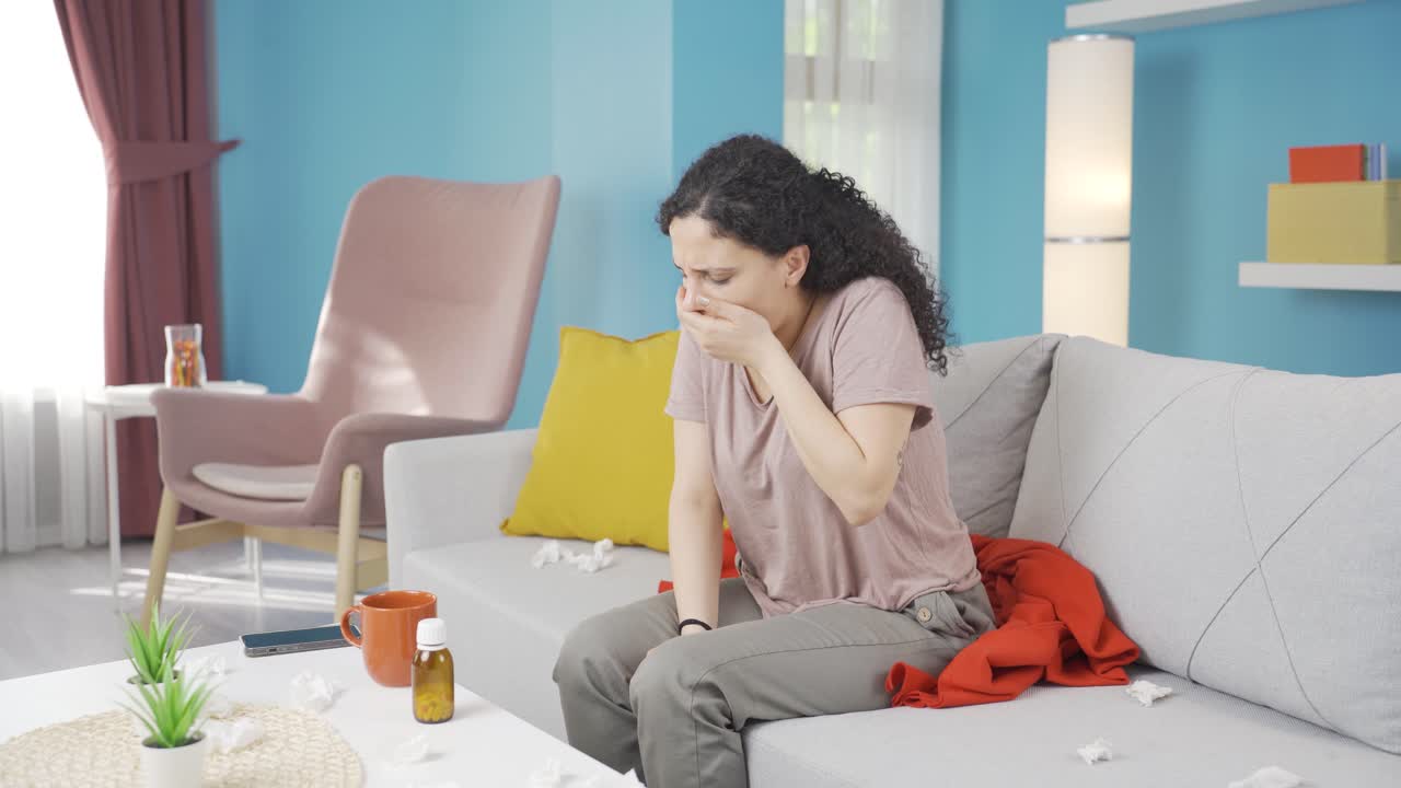 The sick young woman can't stop coughing.
