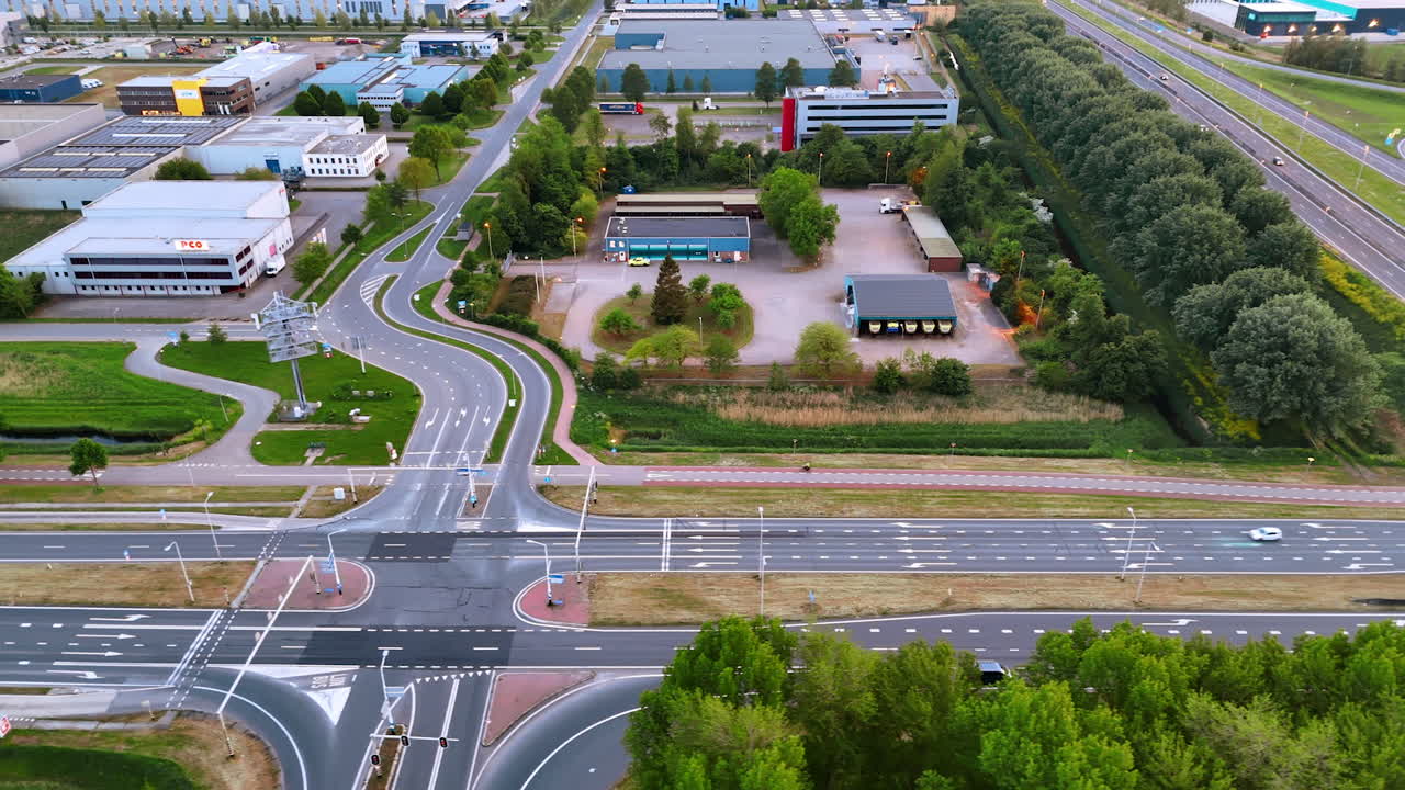 Dutch sunset at busy intersection. Aerial view of a busy Dutch intersection, with traffic and buildings at sunset