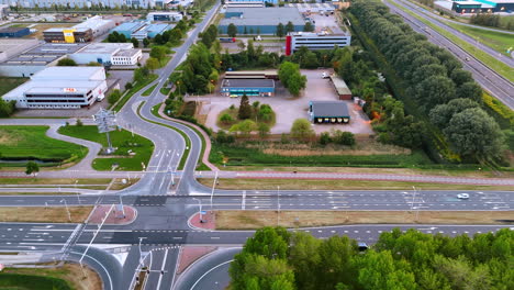 dutch sunset at busy intersection. aerial view of a busy dutch intersection, with traffic and buildings at sunset