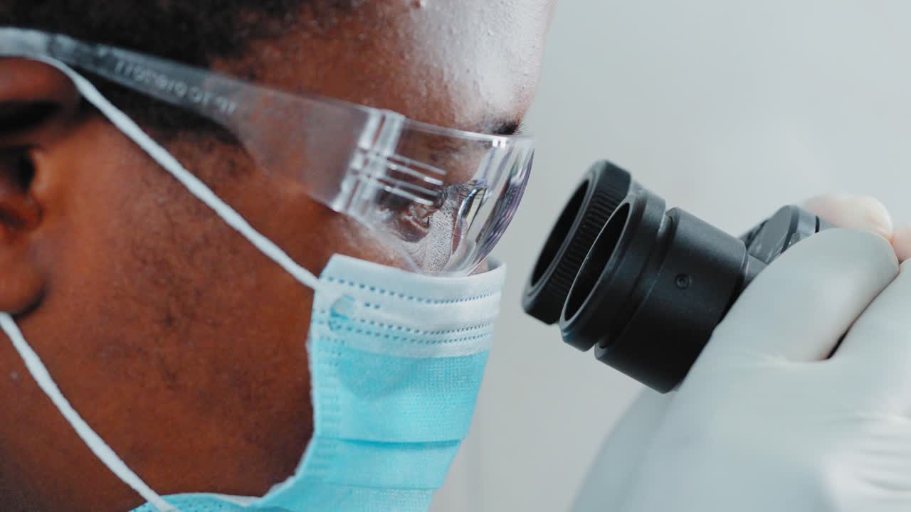 Scientist Looking Through Microscope