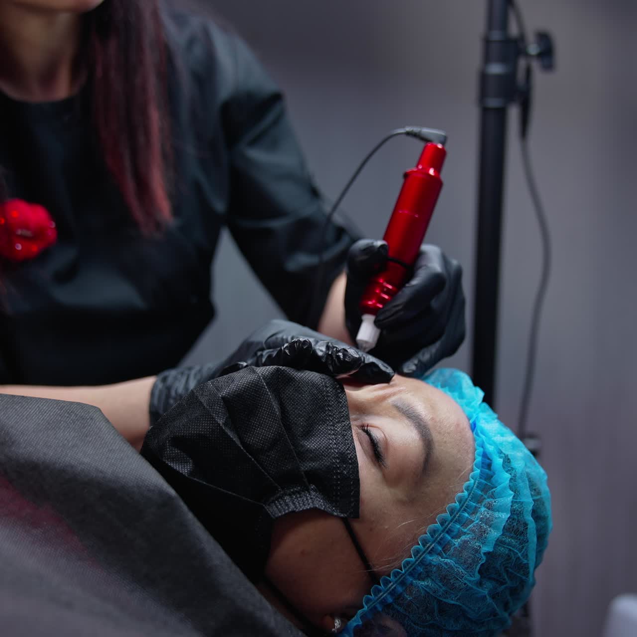 Close up view of cosmetology permanent technologies. Pretty woman cosmetologist working with permanent make up