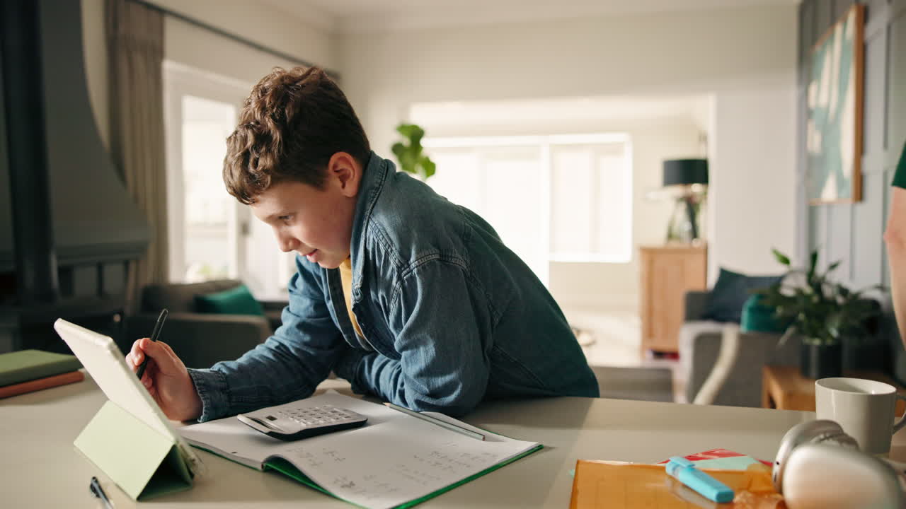 Father assisting son with homework using tablet
