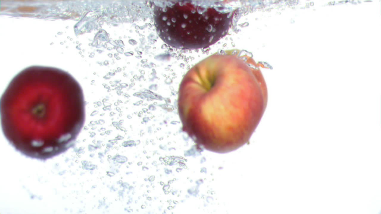사과가 슈퍼 슬로 모션으로 물에 떨어집니다.