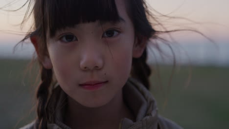 close up portrait beautiful little asian girl looking serious calm little kid wind blowing hair real people series