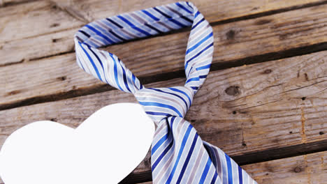 corbata en forma de corazón aislada en una tabla de madera