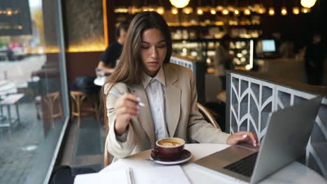woman working on laptop in a cafe