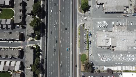 Top-down-pan-up-view-of-highway-traffic-on-101-roof-top-solar-panels-pan-handle-garden