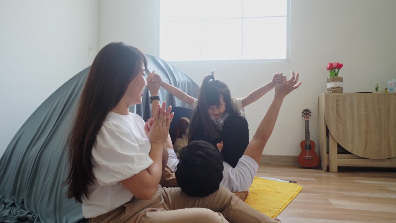 Happy Little Asian Girl, Dad And Mom Playing Airplane Game In Home With Bonding Together