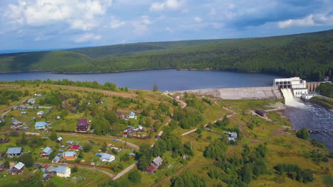 aerial view of a hydroelectric power plant and surrounding village