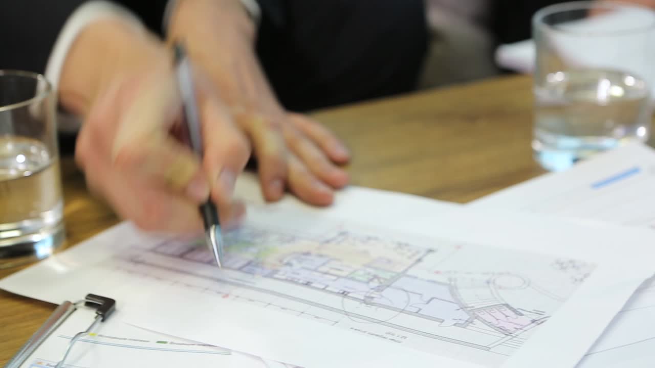 Engineers Discussing Blueprint At Meeting. Business document during discussion at meeting