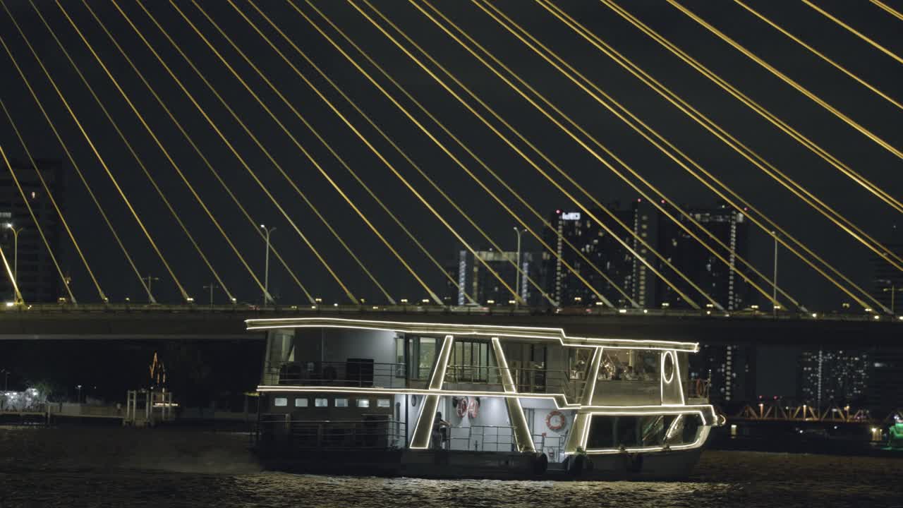 Ferry about to pass under Rama VIII Bridge on Chao Phraya River in Bangkok, Thailand