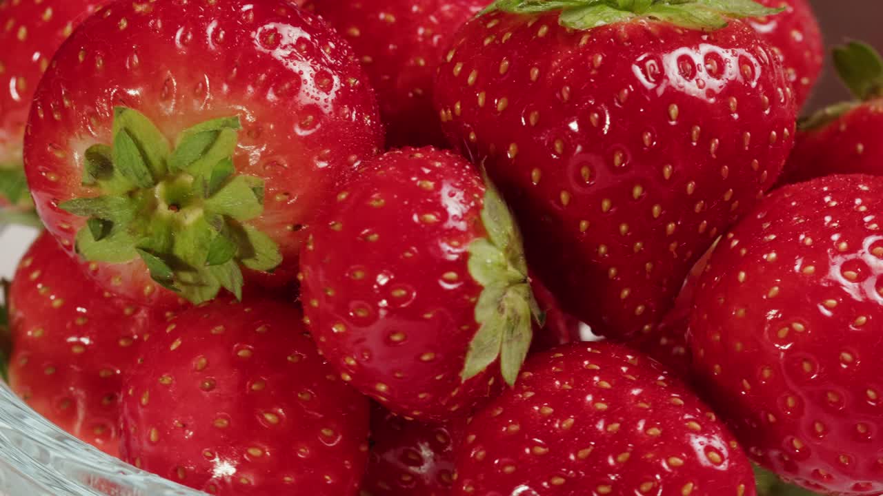 Fresh Red Strawberries Rotating in a Bowl