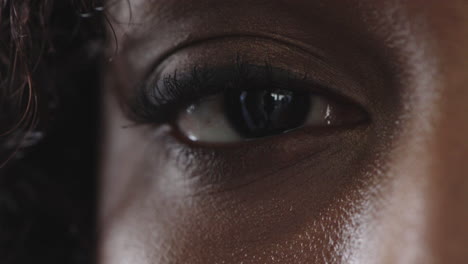 close up of black woman eye blinking looking at camera